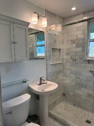 Basic bathroom remodel with pedestal sink and tile shower in Kirkland WA